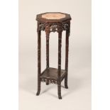 Chinese hardwood jardinière stand, rouge marble insert, octagonal top, carved and pierced leaf and