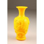 20th century Chinese yellow glass vase, baluster form decorated with dragons in deep relief, 26cm