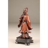 19th century Chinese carved hardwood figure holding a scroll, on a black hardwood base, 30cm high.