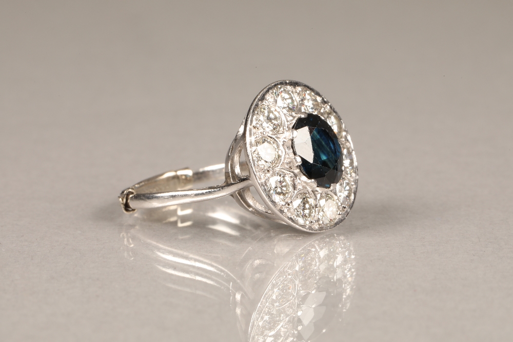 A sapphire and diamond cluster ring, oval dark blue sapphire, surrounded by ten round brilliant - Image 4 of 5