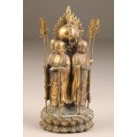 Chinese gilt bronze figure group of four Buddhist monks, standing with their backs to a flaming