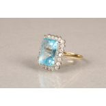 Ladies blue topaz and diamond ring, central blue topaz surrounded by 22 small diamonds on an 18