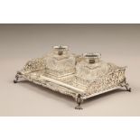 Edwardian silver desk tray, with pierced gallery, twin silver topped ink wells raised on four scroll