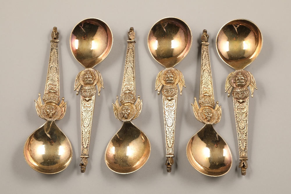 Box of six late 19th century Polish silver gilt spoons, ornate tapered stems with a kings head below