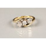 18 carat gold three stone diamond ring, cross over setting set with two 0.33 carat brilliant cut