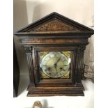 An Edwardian carved pine cased bracket clock with brass and enamelled dial