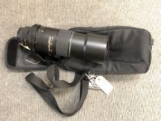 A Nikon AF-S Nikkor 300 mm 1:4 D telephoto zoom lens, with lens hood, with bracket,