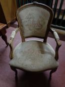 A carved continental tapestry seated armchair
