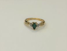 A 10ct yellow gold emerald and diamond ring, approximately 0.25ct emerald, size M.