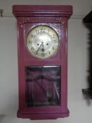 An early twentieth century painted wall clock with silvered dial,