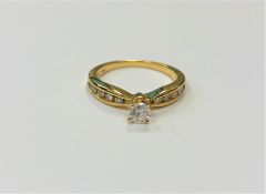 A 14ct yellow gold diamond ring, the central stone approximately 0.