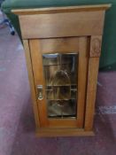 An early twentieth century oak glazed cabinet