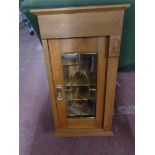 An early twentieth century oak glazed cabinet