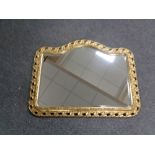 A shaped gilt framed bevelled mirror