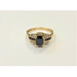 A 10ct yellow gold sapphire and diamond ring, sapphire measures 6 mm x 4 mm, size N.