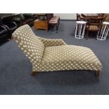 A chaise longue upholstered in spotted fabric and piano stool
