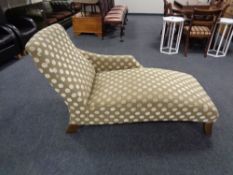 A chaise longue upholstered in spotted fabric and piano stool