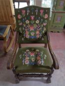 An early twentieth century oak armchair with tapestry covering