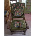 An early twentieth century oak armchair with tapestry covering