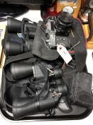 A tray of two pairs of binoculars,