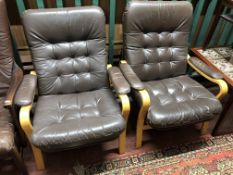 A pair of brown buttoned leather beech framed armchairs CONDITION REPORT: Width 72