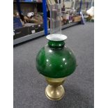 A brass Aladdin oil lamp with chimney and green glass shade