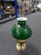 A brass Aladdin oil lamp with chimney and green glass shade