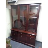 A Stag triple door display cabinet fitted with drawers and cupboards beneath