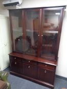 A Stag triple door display cabinet fitted with drawers and cupboards beneath