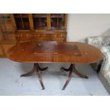 A mahogany twin pedestal extending dining table with leaf