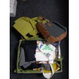 A luggage case and a holdall of clothing, new tea towels,