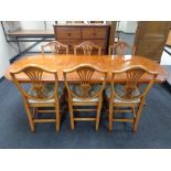 An inlaid yewwood extending dining table and set of six chairs CONDITION REPORT: