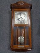 An Edwardian oak wall clock