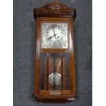 An Edwardian oak wall clock