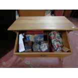 A light oak storage sewing table