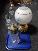 A brass and glass oil lamp together with claret jug and decanters