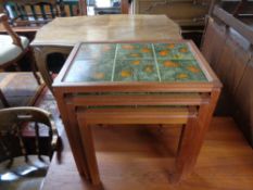 A nest of three Danish teak tiled top tables