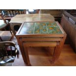 A nest of three Danish teak tiled top tables