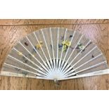 A nineteenth century ivory hand fan with painted lace decoration depicting butterflies