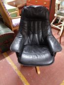 A contemporary black leather relaxer chair