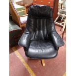 A contemporary black leather relaxer chair