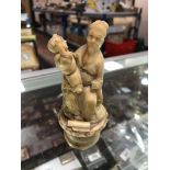 An antique carved ivory figure - Oriental gentleman with child