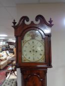 A nineteenth century mahogany longcased clock with painted dial, pendulum and weights.