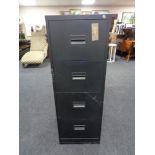 A four drawer metal filing cabinet with key