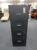 A four drawer metal filing cabinet with key