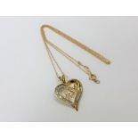 A 10ct yellow gold diamond heart pendant on yellow gold chain, approximately 0.25ct.