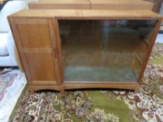 An Edwardian glazed door bookcase fitted a cupboard