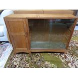 An Edwardian glazed door bookcase fitted a cupboard