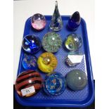 Twelve decorative glass paperweights.