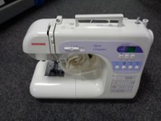 A Janome DC 3050 Decor computer sewing machine with pedal